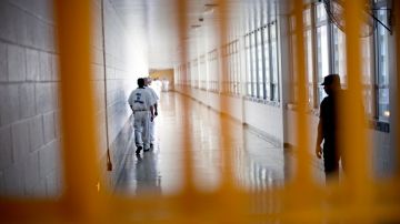 FILE - In this March 3, 2011 file photo, a guard looks on, at right, as prisoners move through the state prison in Jackson, Ga. After years of middling progress, Georgia lawmakers could soon adopt reforms to overhaul the state's clogged, and expensive, prison system. (AP Photo/David Goldman, File)